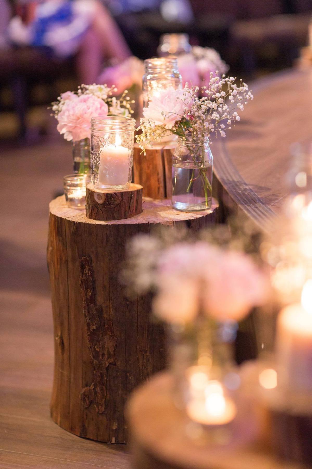 Candles and flowers on a wood-round table