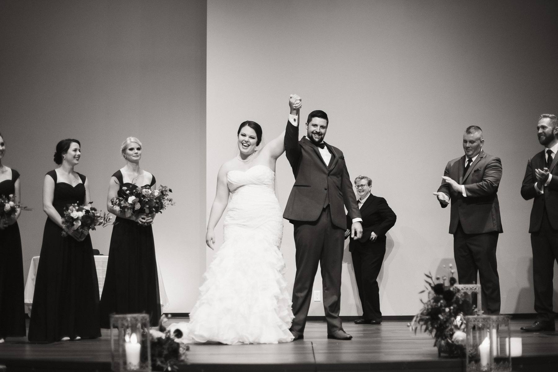A just-married couple celebrating on stage